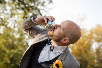 Groom shotguns a beer on his wedding day