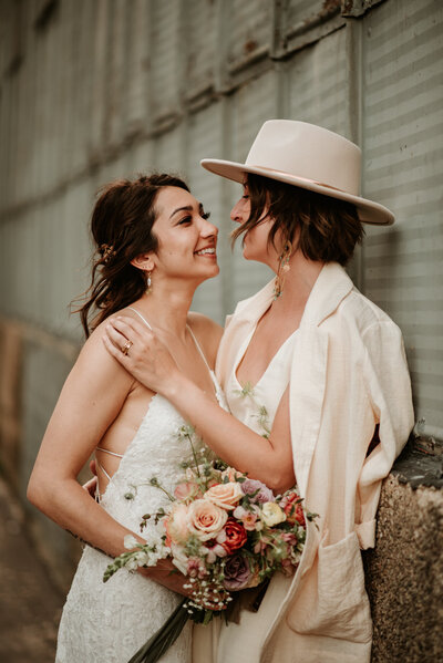 bride and bride smiling at each other