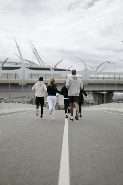 Runners group running on road faced away from camera