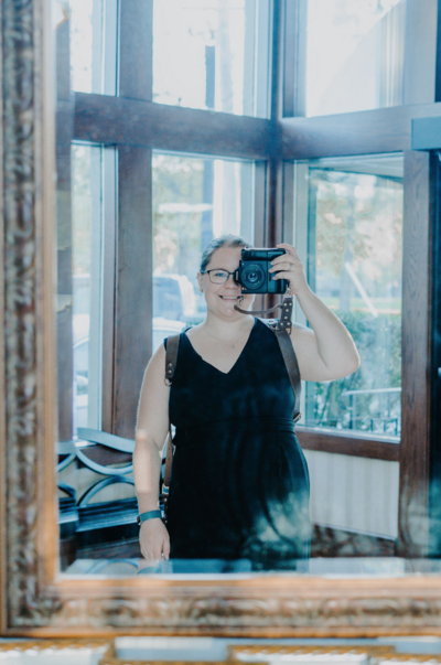 photographer erin gage taking a photo of herself with a mirror reflection
