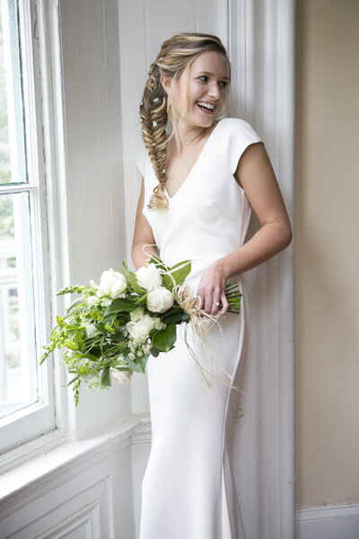laughing bride in BHLDN dress at Awbury Arboretum Phila PA