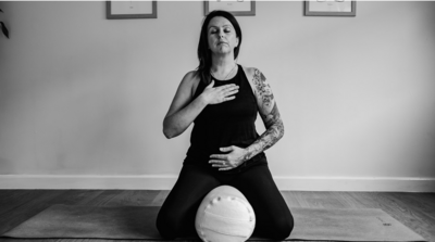 Image of a yoga teacher adopting a tree pose in the studio in Wells, Somerset