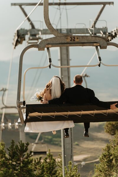 Bride and groom on Colorado ski lift