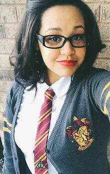 Hispanic American wearing a grey Gryffindor sweater, gold and maroon tie and a white shirt