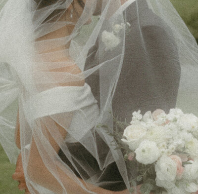 Intimate wedding portrait of a bride and groom sharing a quiet moment together in an outdoor setting