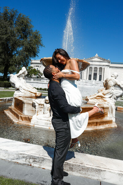 An engaged couple posing at Cleveland Museum of Art.