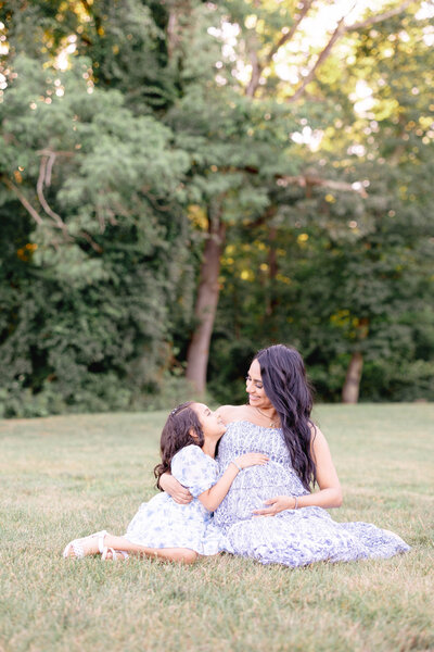 Newport Photographer Serving CT, RI, and beyond | The Corteses | Photo of a beautiful pregnant woman with her daughter sitting on the grass