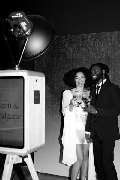 couple using a print photo booth at their wedding