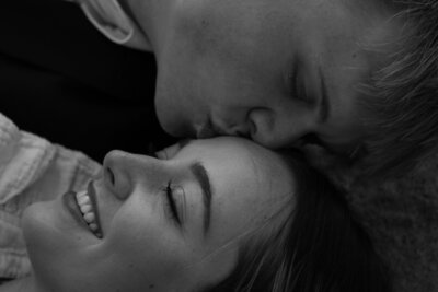 Wyatt kissing Mya on the forehead, in black and white