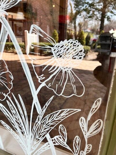 Hand drawn modern florals on storefront windows of Cheshire, Connecticut business