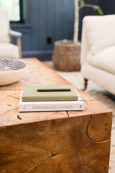 Stack of books on top of a beautiful wood coffee table