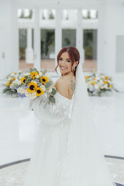 Eagle Oaks Golf Club Wedding | Bride Smiling Inside Majestic Glass Conservatory | Farmingdale, New Jersey