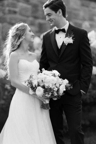 A bride and groom kiss their dog lovingly at the Hinterland. 