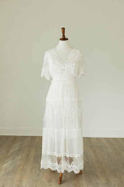 White lace dress with bell sleeves and buttons on bust