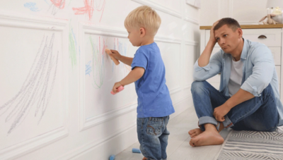 toddler coloring on wall