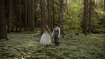Bride and groom standing to forest