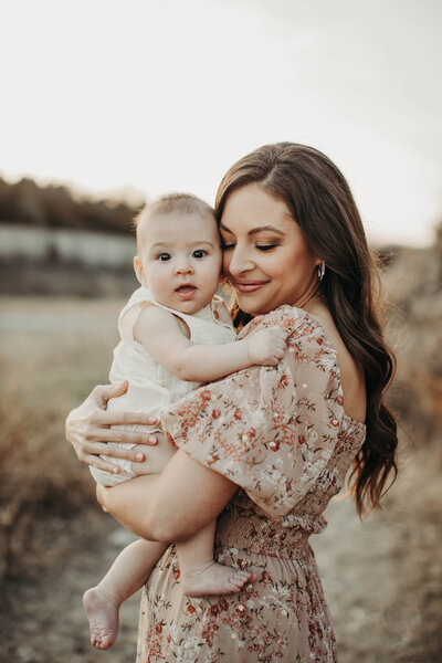 Mom embracing son and smiling. 