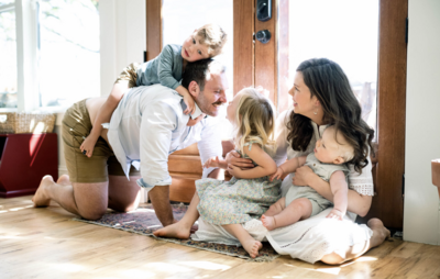 Family of five playing on the floor at home