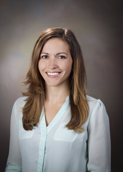 woman smiling in a light blue shirt