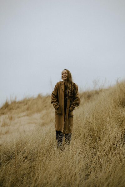A wedding photographer at Indiana Dunes National Park on an overcast day. 