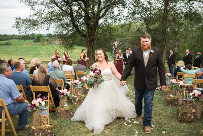 Couple walking back up aisle at the end of their outdoor ceremony at Jon Haven Farm