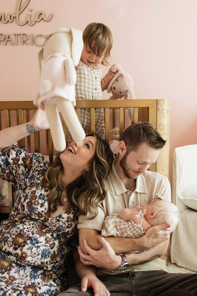 A sweet family moment captured during a Cleveland lifestyle newborn photography session, highlighting the joy and connection between parents, siblings, and their newest addition.