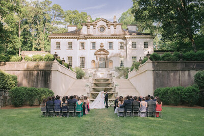 A wedding ceremony in front of the stairs at the Swan House in Atlanta.