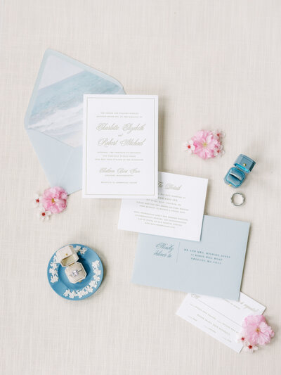 Blue and white coastal invitation  suite with rings and pink flowers