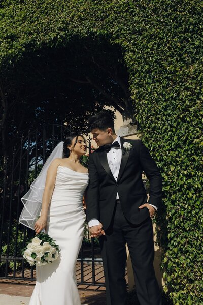 husband and wife lean in for a kiss after wedding