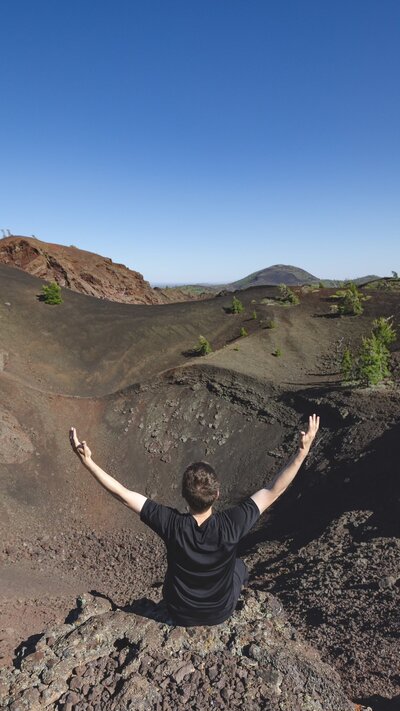 Man stands in front of crater mountain park