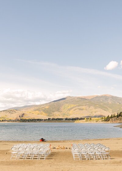 Chairs set up lakeside with mountains in background for outdoor ceremony — Colorado mountain wedding venue