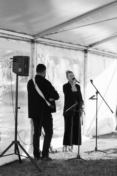 vocalist and guitarist performing a wedding ceremony at dunes palm beach in Sydney.