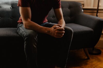 Man sitting on couch with anxiety
