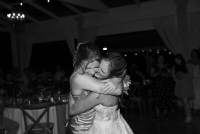 Bride and friend hugging emotionally