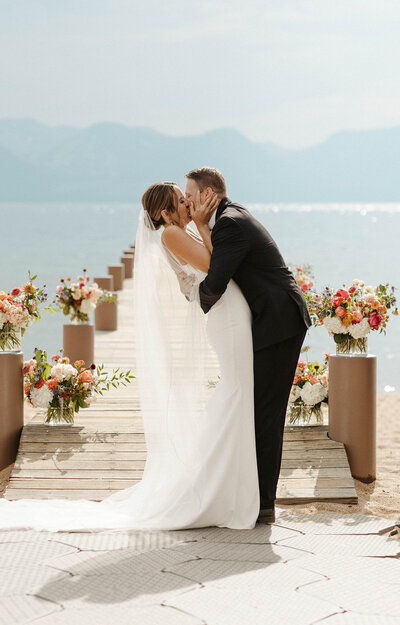bride and groom holding each other in lake tahoe
