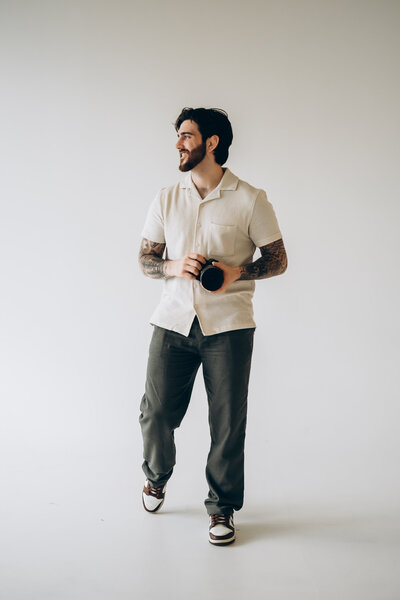 A person holding a camera and looking off to the side