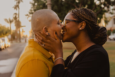 A queer couple sharing a kiss.