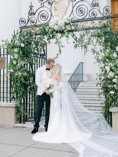 Couple kissing in front of Hibernian Hall wedding in Charleston, South Carolina