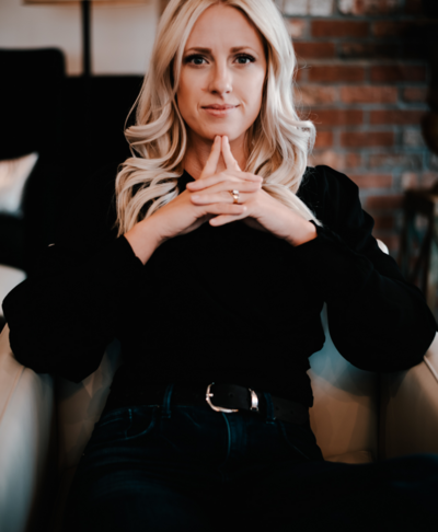 Personal brand portrait of Ally Saunders with hands in front of face, capturing a thoughtful and strategic vibe