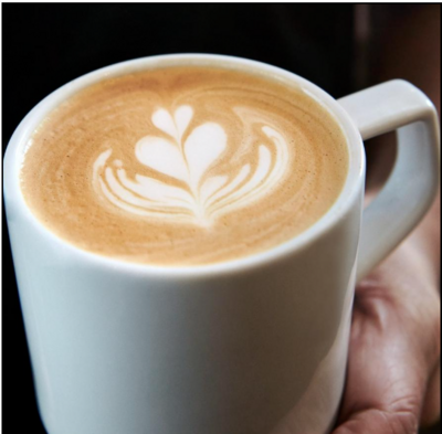 white cup of coffee with design in the foam