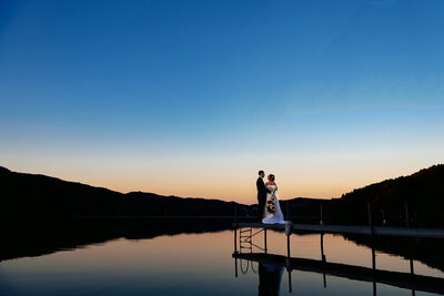 Wedding Couple standing on the dock of lake morey resort