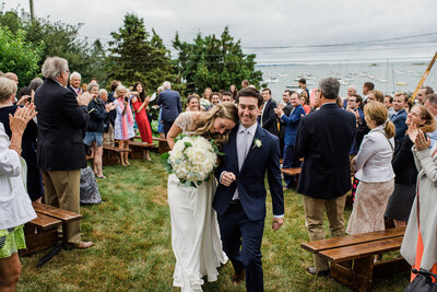 bride and groom walking down aisle emotional