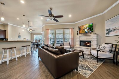 Living room with ample seating, fireplace, and amazing view at this three-bedroom, two-bathroom vacation rental lake house that sleeps eight just steps away from Stillhouse Hollow Lake in Belton, TX.