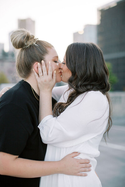 Two brides kissing on wedding day