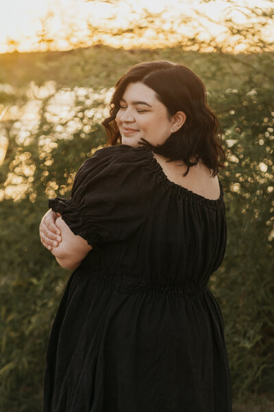 A person smiling and looking back over their shoulder 