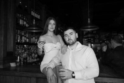 Tori and Blake having a drink at Stingy Alley for their engagement photos