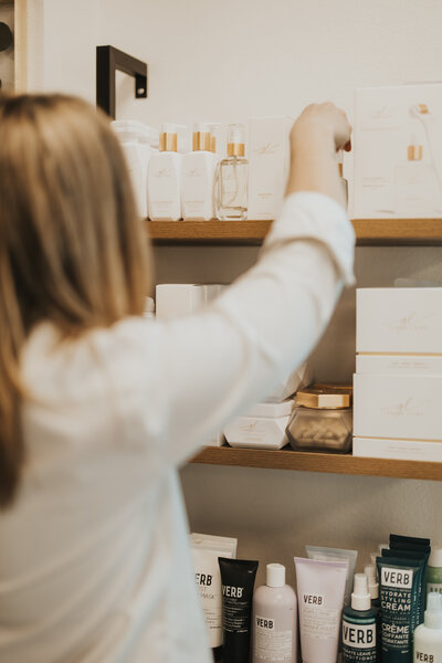Emily Muhlbauer choosing the right product for her hair restoration and gray blending client