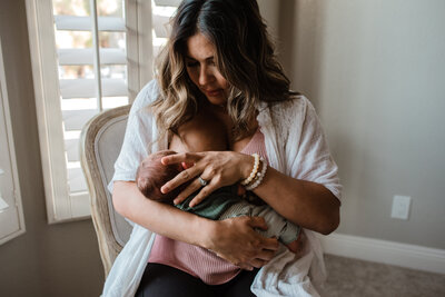 Mother breastfeeding infant with correct latch