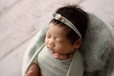 baby girl with a mint green flower headband