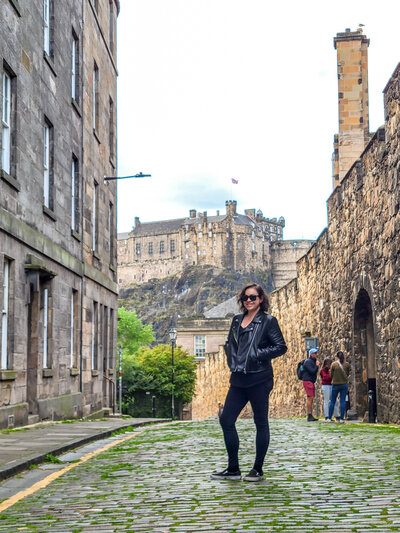 Standing on an old street with Edinburgh Castle in the background